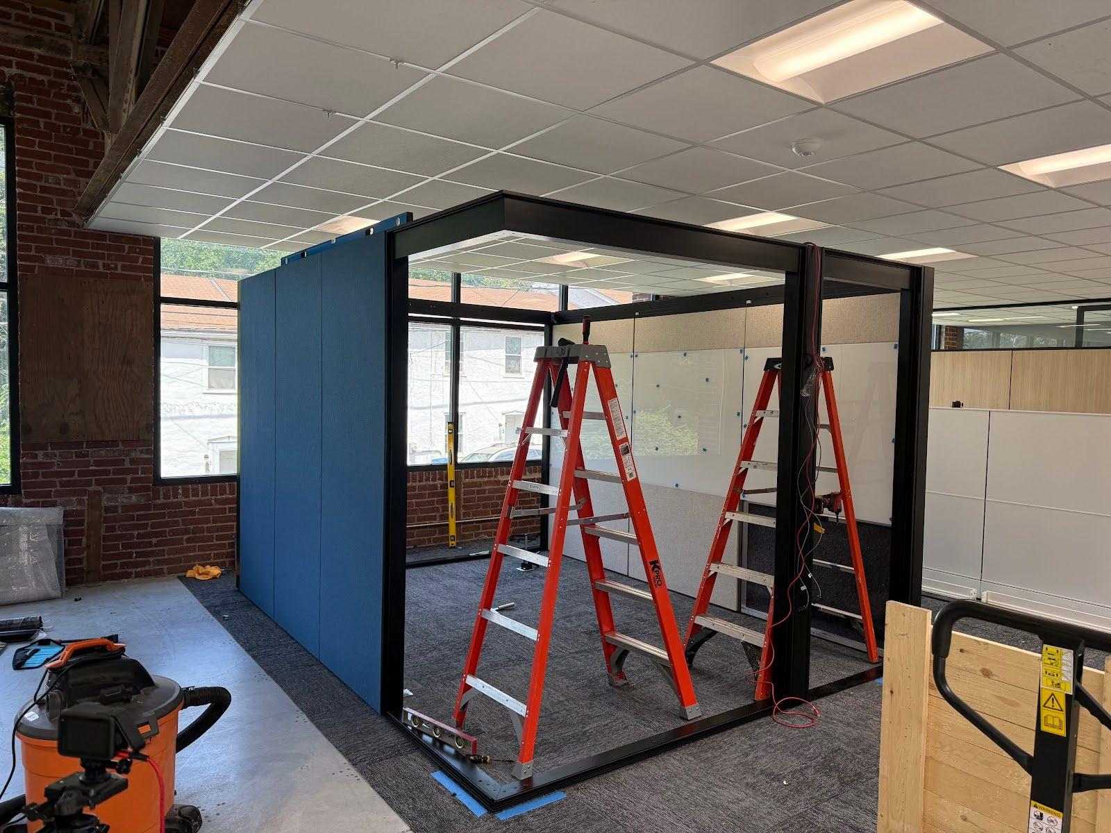 Glass highwall office enclosure being built