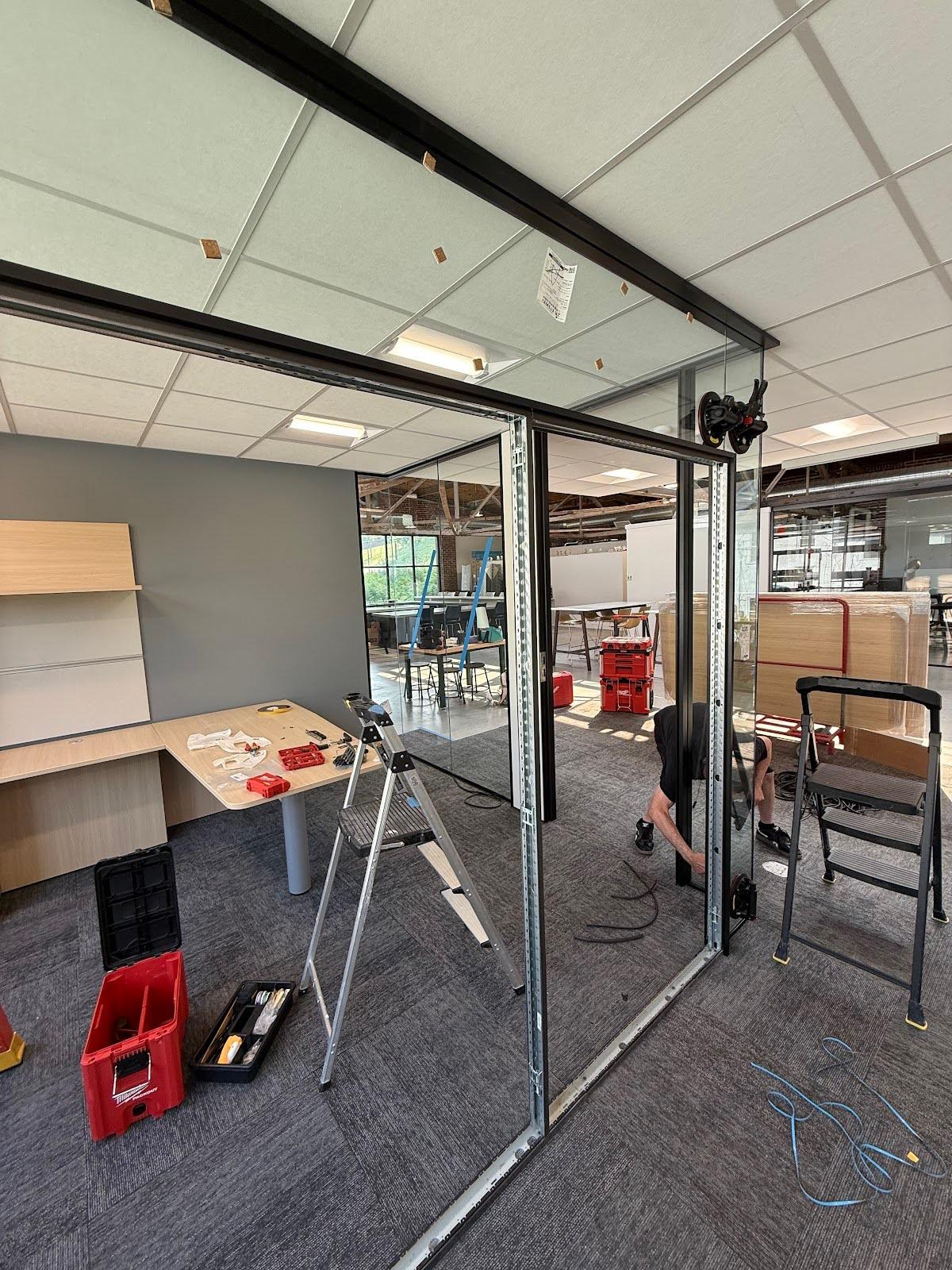 Glass partition installation in progress